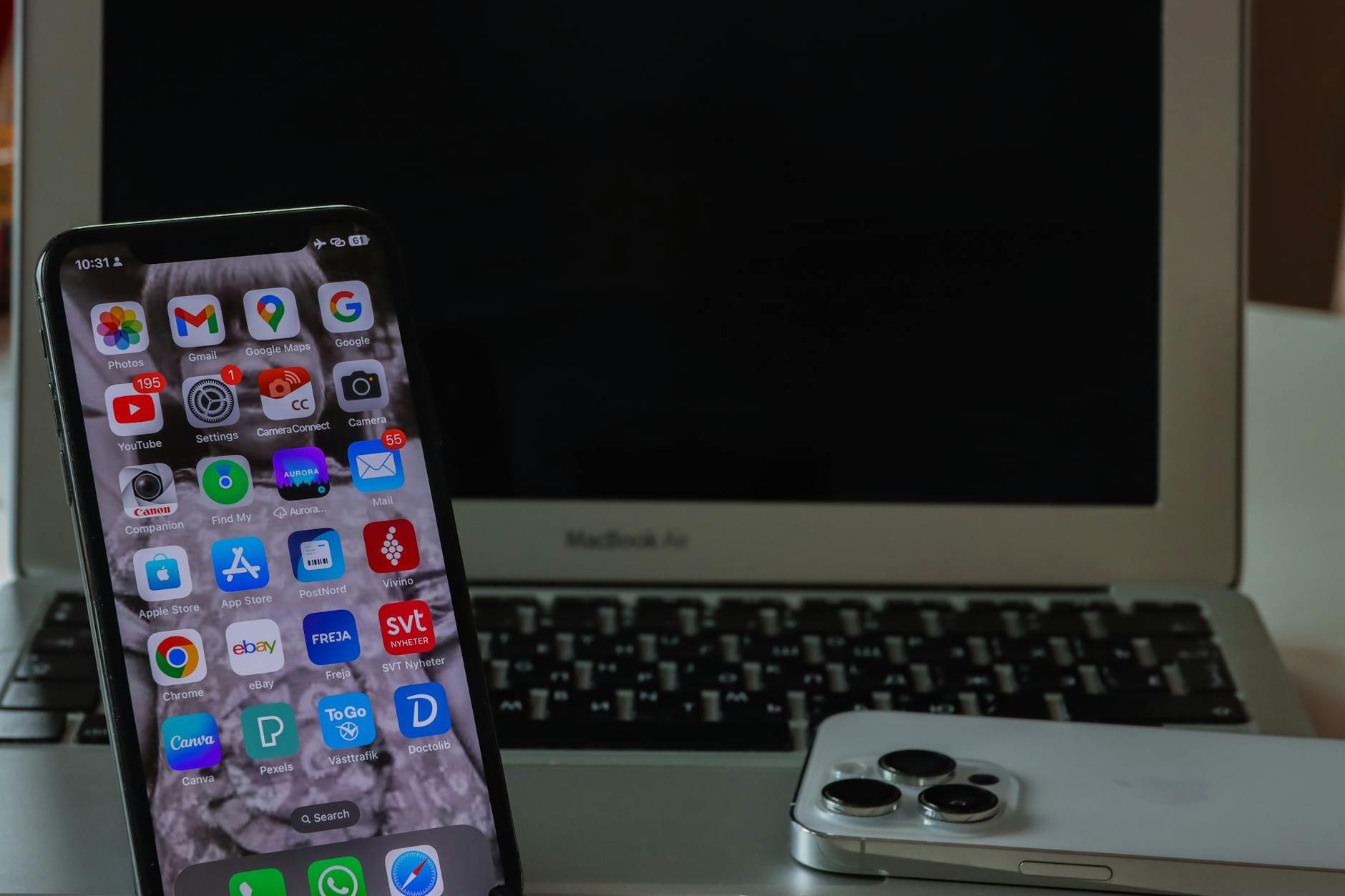 smartphone and laptop on desk setup